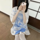 White Animecore Aesthetic Tee with a blue and white cloud print, worn by a person taking a photo.