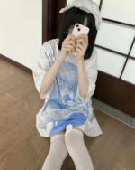 White Animecore Aesthetic Tee with a blue and white cloud print, worn by a person taking a photo.