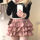 Pink Yume Kawaii Aesthetic ruffled mini skirt layered with a black sweater.
