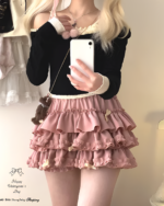Pink Yume Kawaii Aesthetic ruffled mini skirt layered with a black sweater.