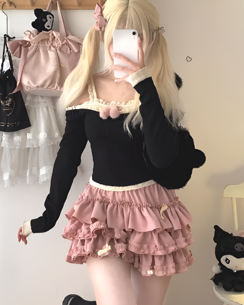 Pink Yume Kawaii Aesthetic ruffled mini skirt with lace trim, layered over a black top.