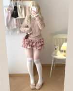 Pink ruffled mini skirt, Yume Kawaii Aesthetic, featuring a sweater and stockings.