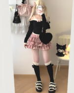Yume Kawaii Aesthetic ruffled mini skirt styled with a black sweater, thigh-high socks, and platform shoes.