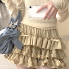 Yume Kawaii Aesthetic ruffled mini skirt in beige, featuring multiple layers and ruffles.