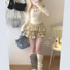 Model wearing a beige ruffled mini skirt with Yume Kawaii Aesthetic details.