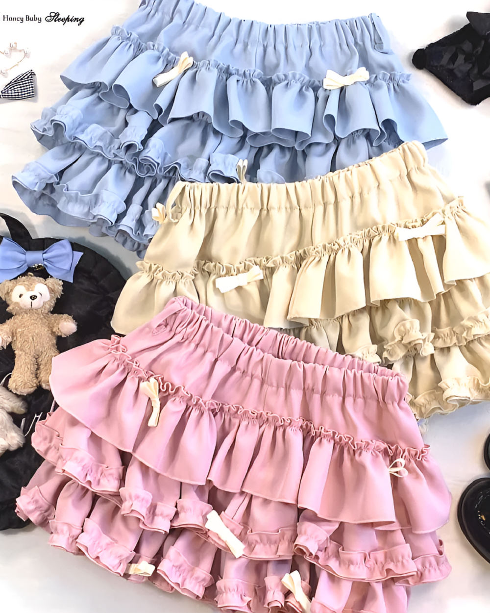Stack of Yume Kawaii Aesthetic ruffled mini skirts in pastel colors, featuring a layered ruffles design and bow accents.