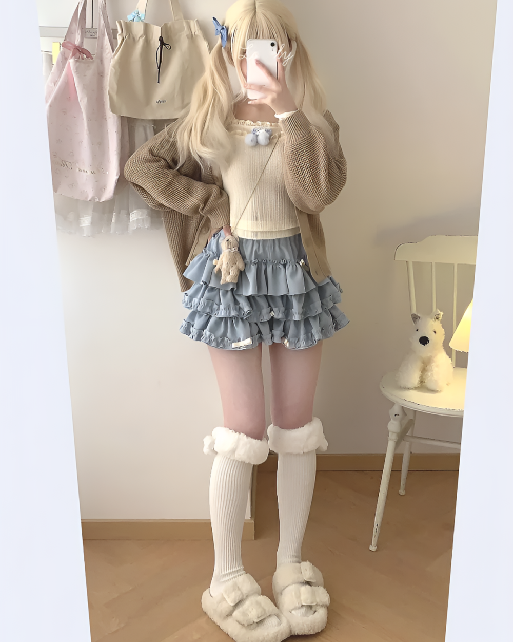Model wearing a blue ruffled mini skirt, part of the Yume Kawaii Aesthetic, with a cream-colored cardigan and fuzzy socks.