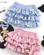 Two Yume Kawaii Aesthetic ruffled mini skirts, one light blue and one pink, with bows. Props included.