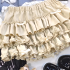 Yume Kawaii Aesthetic ruffled mini skirt, light beige, layered ruffles, detailed close-up.