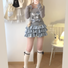 Yume Kawaii Aesthetic ruffled mini skirt paired with a sweater and socks, showing a layered outfit.