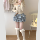 Yume Kawaii Aesthetic mini skirt with ruffles, worn with a long-sleeved sweater and fluffy socks.