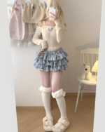 Yume Kawaii Aesthetic mini skirt with ruffles, worn with a long-sleeved sweater and fluffy socks.