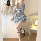 Yume Kawaii Aesthetic ruffled mini skirt, light blue, layered with a long-sleeved shirt and socks.