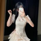 A person wearing a Qi Lolita Dress, a cheongsam-style cute dress with ruffles and lace details.