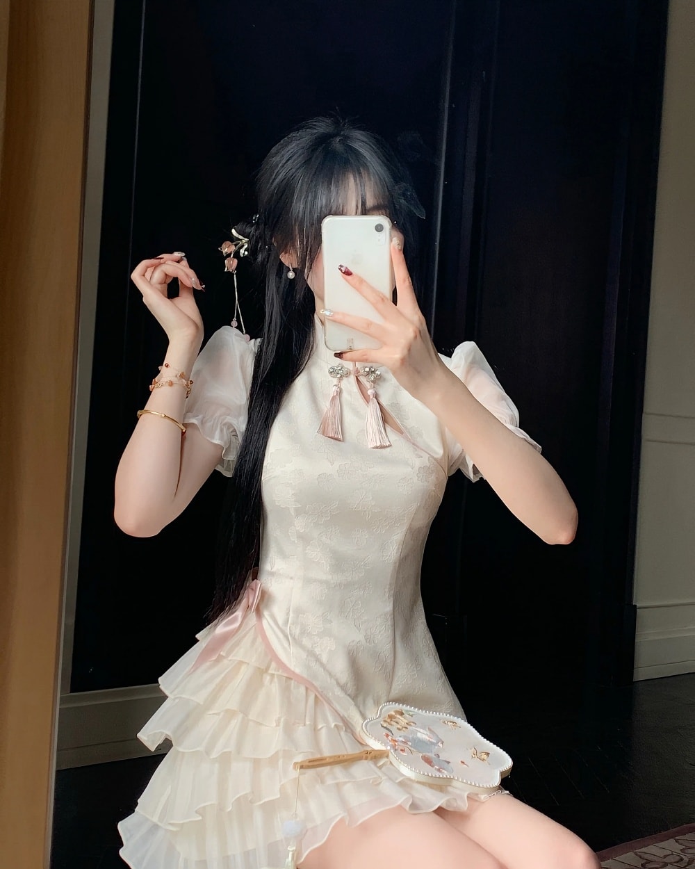 A person wearing a Qi Lolita Dress, a cheongsam-style cute dress with ruffles and lace details.