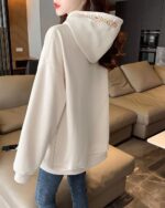 Cream-colored Ethno-Chic Hoodie featuring embroidered details, thick fabric.