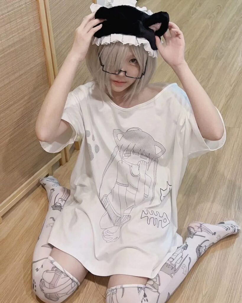 Model wearing a Cat Girl Oversized T-Shirt with anime cat ears and a maid headband.