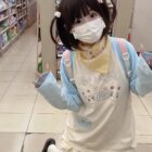 Person wearing a Kawaii Panda Pastel Long Sleeve t-shirt in a store.