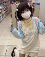 Person wearing a Kawaii Panda Pastel Long Sleeve t-shirt in a store.