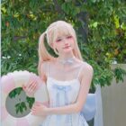 Model wearing a blue Lolita Inspired Swimwear outfit with a pink floatie.