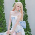 Model wearing a blue Lolita Inspired Swimwear, featuring a corset top and shorts, outdoors.