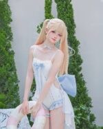 Model wearing a blue Lolita Inspired Swimwear, featuring a corset top and shorts, outdoors.