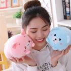 Pink and blue Squishy Animal Plushies - Mini Plush Edition, held by a woman.