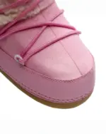 Close-up of Pink Fluffy Boots, featuring faux fur lining and laces.