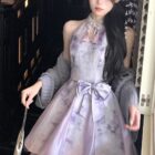 A light purple Qi Lolita Dress with a bow, featuring a floral print and lace detailing.