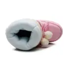 Close-up of Pink Fluffy Boots featuring a fluffy lining and pom-poms.