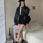 Woman wearing a black Korean Style Jacket with a collared shirt and black pants.