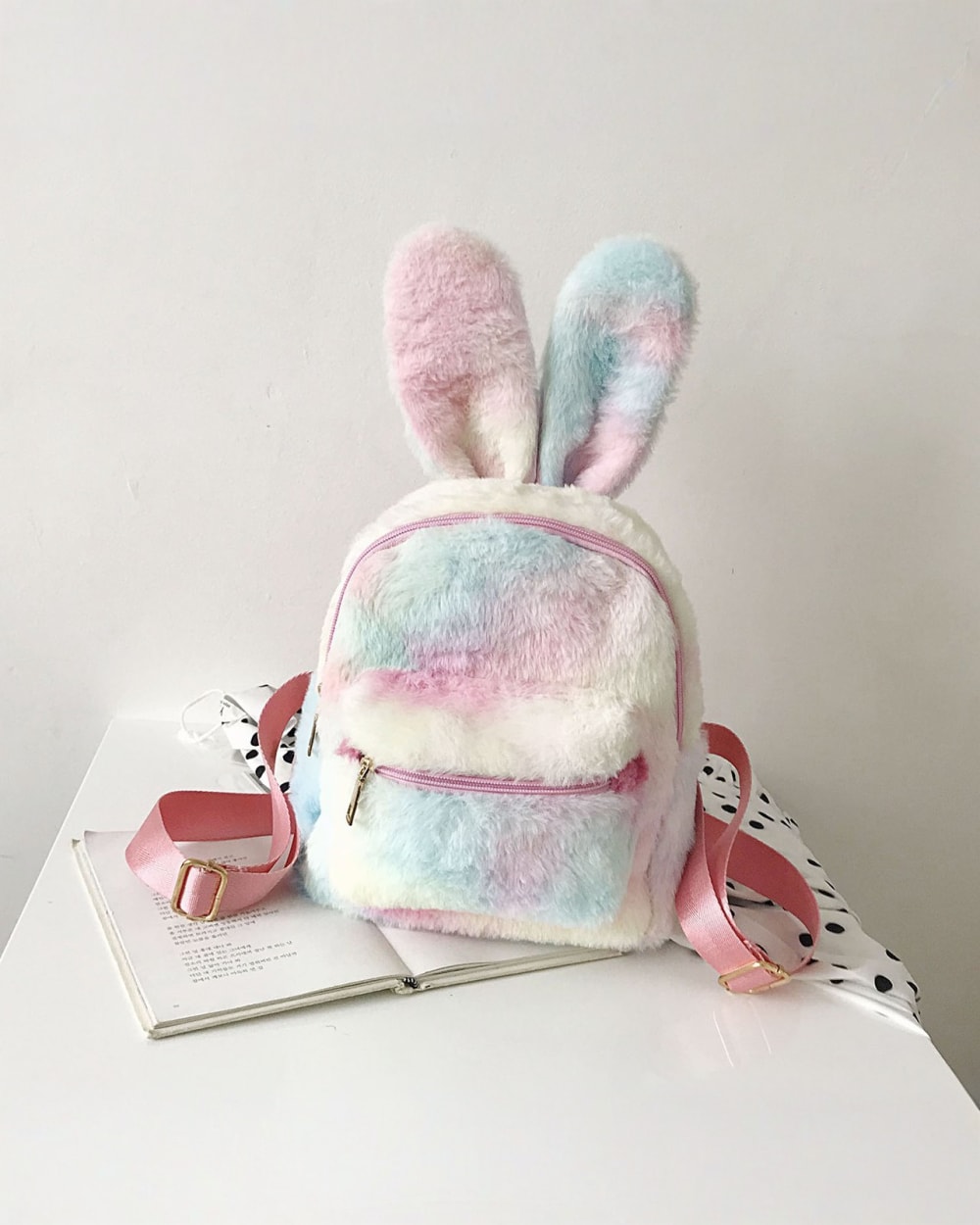 Cute Rabbit Ears Plush Backpack, a soft pink and white backpack with bunny ears and shoulder straps.