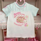 Mezzo Piano Top featuring a strawberry shortcake design and pastel color palette.