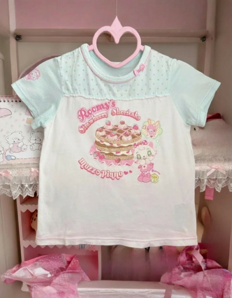 Mezzo Piano Top featuring a strawberry shortcake design and pastel color palette.