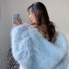 Light blue Thick Fluffy Faux Fur Coat draped over a person's shoulders.