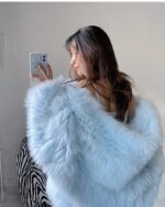 Light blue Thick Fluffy Faux Fur Coat draped over a person's shoulders.