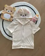 Kuma Zip Up Hoodie - Jojifuku Hoodie displayed with plush toys on a rug.