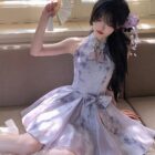 Model wearing a Qi Lolita Dress, a cheongsam-style cute dress with a floral accent.