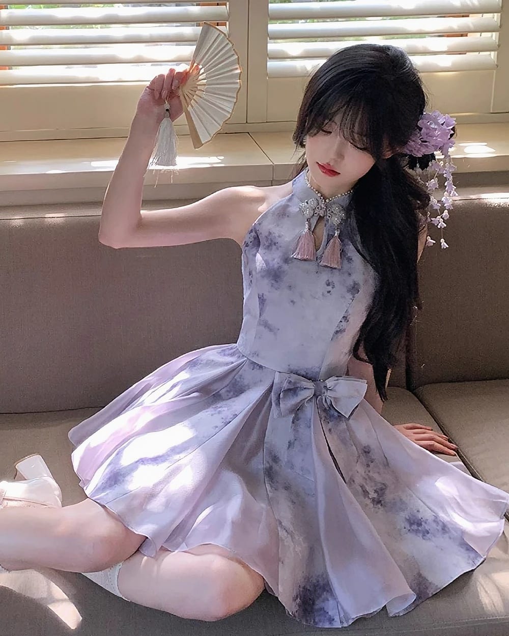 Model wearing a Qi Lolita Dress, a cheongsam-style cute dress with a floral accent.