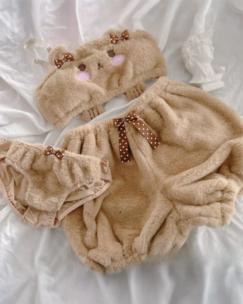 Close-up of Soft Plush Bear Pajamas - Kawaii Clothes, featuring a brown plush jumpsuit with bow accents.