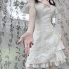 White lace Qi Lolita Dress with ruffled layers and a high collar.