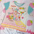 Mezzo Piano Print Top featuring a whimsical cartoon design and star accents.