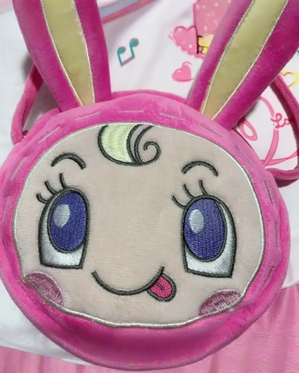 Close-up of the Mezzo Piano Cross Body Bag, featuring a cute, plush bunny design with pink accents.