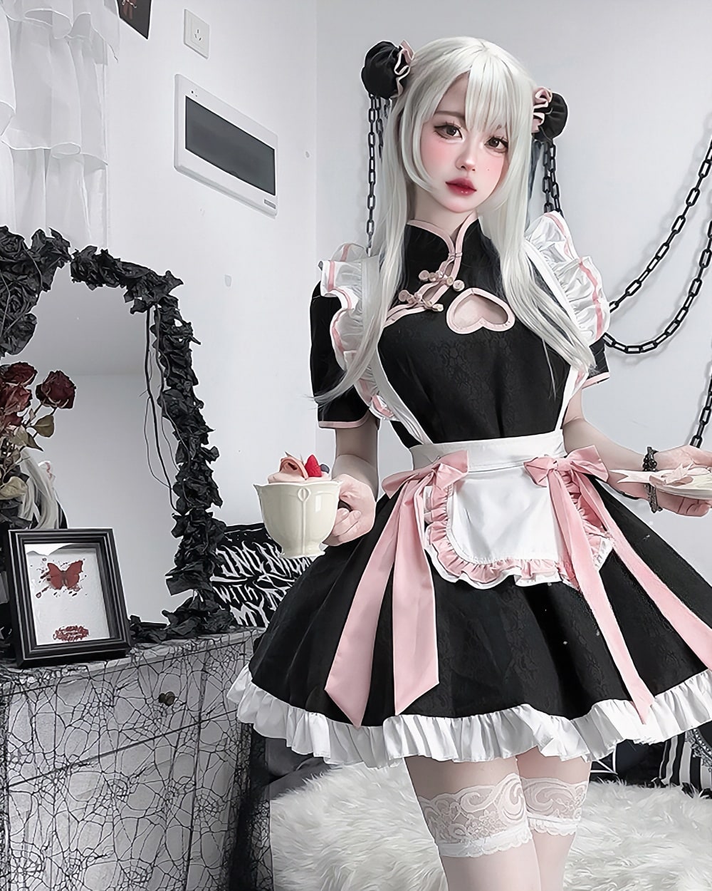 Black and pink Kawaii Maid Dress with frills, worn by a model. Cute cosplay outfit for girls and women.