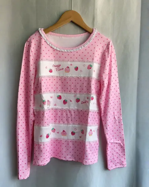 Mezzo Piano Shirt featuring a pink polka dot design with strawberry and heart motifs.