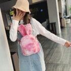 Pink Rabbit Ears Plush Backpack worn by a woman in a public space.