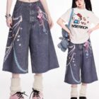Blue denim Y2K Aesthetic Pants with chain and flower embellishments.