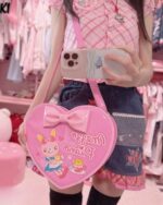 Pink Heart Shaped Cross Body Bag Jojifuku Aesthetic carried by a person.