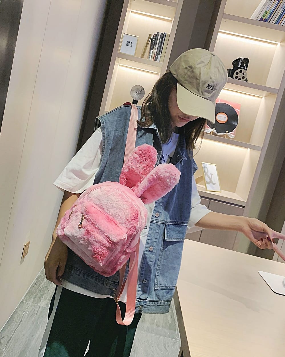 Pink Rabbit Ears Plush Backpack worn as a casual shoulder bag.