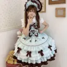 A young woman wearing a Frilly Ribbon Dress - Hime Lolita Dress, featuring a pale blue and brown color scheme with ruffles and bows.